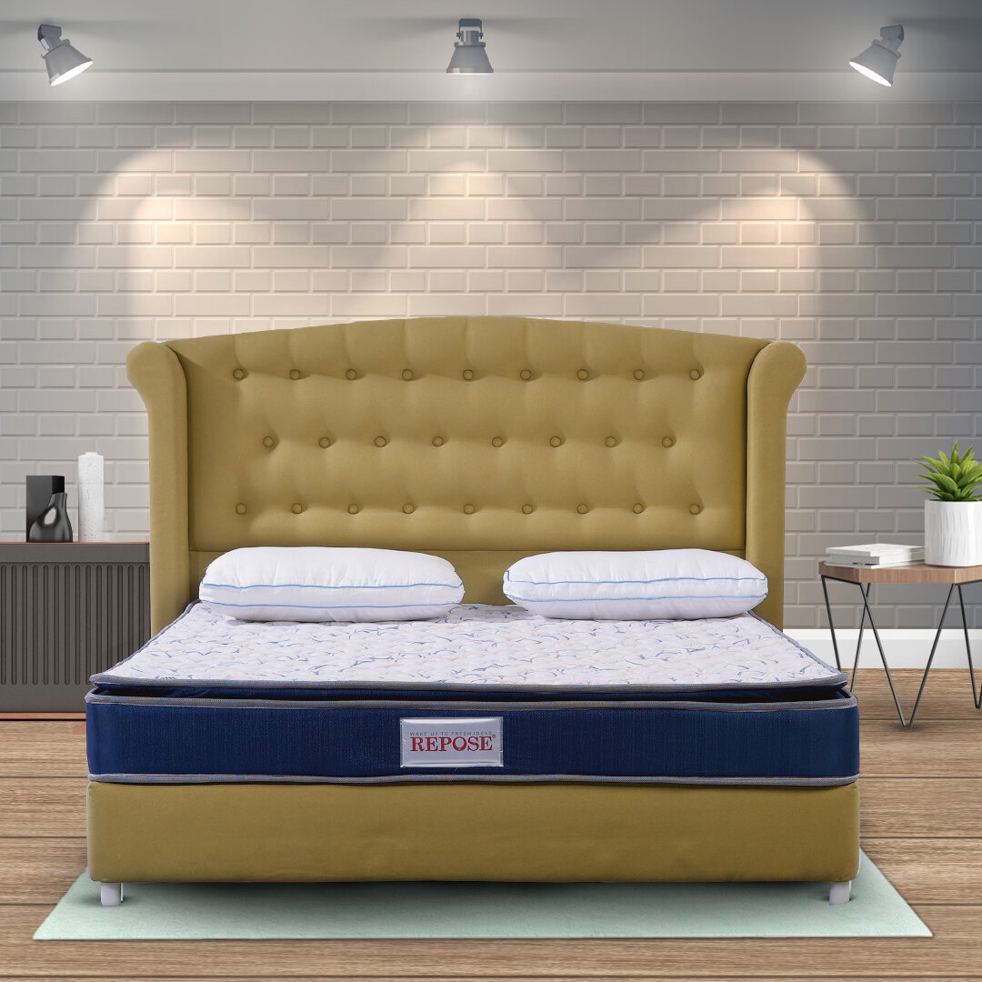 Resilient mattress neatly installed in residential bedroom